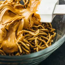 Stirring Melted Butterscotch Chips With Chow Mein Chinese Noodles Haystacks Recipe Foood Recipes Homemade Snacks