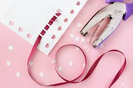 Buddy up with a friend for free shipping over $85 choose a catagory below. A Close Up Image Of Card Making Supplies Including Red Ribbon A Paper Punch And White Heart Confetti On A Pink Background Stock Photo Picture And Royalty Free Image Image 17443890