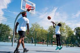 As a certified versacourt partner, chattanooga concrete co, can assist with all elements of incorporating a basketball court into your backyard design. Father And Son Playing Basketball On Basketball Court Stockphoto
