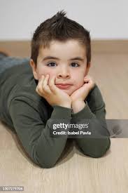 Portrait Of Girl Lying On Hardwood Floor At Home Romania High-Res Stock  Photo