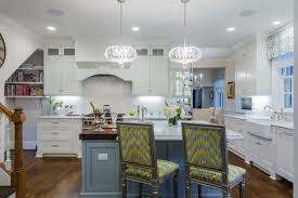 Blue has a lot of versatility as a color and can act as a substitute for a white or a black if you pick a very light or very dark hue respectively. White Kitchen With Light Blue Painted Island Crystal Cabinets