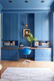 A colorful feminine home office with a hot pink stool, a gold scale pendant lamp and a bright gallery wall. 15 Modern Home Offices Work From Home Decorating Tips