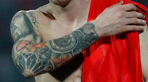 A tattoo of jesus' face with a crown of positions of royalty sits upon this football legends right arm. Lionel Messi S Tattoos Explained What Do They Mean Whereabouts On His Body Are They Goal Com