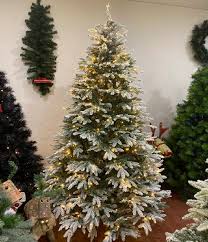 The tree's thick white flocking conjures up images of evergreens dusted with freshly fallen snow, while its slim, downswept silhouette allows you to add holiday cheer to small corners and limited spaces. The Colombian Pre Lit Artificial Christmas Tree Snow Flocked Green 7 Foot The Christmas Tree Company