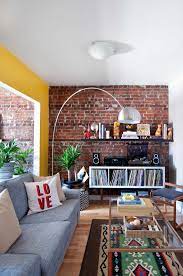 A Couple Gets Creative With The Layout Of Their Small Colorful Rental Brick Wall Living Room Brick Living Room Apartment Decorating Rental