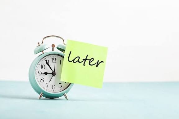 Procrastination, delay and urgency concept. bad time management. word later  sticked to alarm clock | Premium Photo