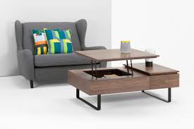 The top of this coffee table lifts up and forward to create an elevated and versatile work surface for sharing a snack, playing games with your friends or intricate and thoughtful details include elegant tapered feet and a faux drawer front. Flippa Functional Coffee Table With Storage Walnut Made Com