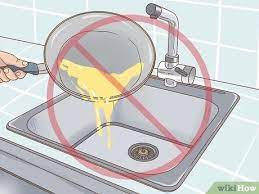 Give the water time to cool for about five minutes and then remove it by scooping out as much cooled water as possible with a small jug or container and disposing of it in another sink or toilet. 3 Ways To Avoid Kitchen Sink Blockages Wikihow
