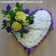 This style of funeral flower comes in the shape of an attractive arrangement and one that is suited both to the service and the home. Heart Funeral Tribute Purple Ribbon Funeral Flowers Leicester