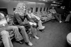 The photo of Robert Plant relaxing on a fur-covered bed aboard their private jet in 1973 captures a moment of luxury and indulgence during the band's zenith. At this time, Led Zeppelin