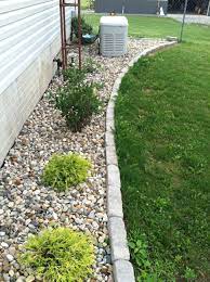 River Rock In Places That Are Hard To Mow Around Like The Generator And Antenna Towe Landscaping With Rocks Small Front Yard Landscaping Rock Landscaping Ideas