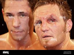 German boxer Felix Sturm, left, and boxer Gavin Topp from Australia, right,  pose for the photographers after a WBA middleweight boxing fight in Berlin,  Germany, Saturday, Dec. 2, 2006. Felix Sturm won