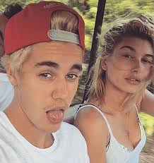 Jordan Barrett and Hailey Baldwin appear