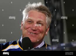 St. Louis Blues Brett Hull (16) and Bob Bassen are held by the New York  Islanders Wayne McBean (6) while teammates Bill Berg (4) and goalie Glen  Healy (34) look for the
