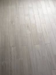 Lowe S Eldon White Wood Look Porcelain Tile With Silver Grout From Menards Wood Look Tile Floor Flooring Wood Look Tile