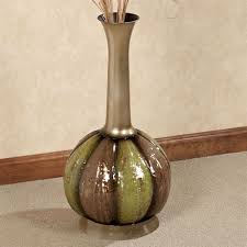 The metallic colored vase has a unique design that allows it stand by itself for a unique decorative element or be paired with any of the other 5 metal floor vases to create an installment that is sure to be a conversation piece. Eclipse Decorative Metal Vase
