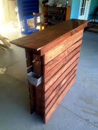 The table features a butcher block table top and sits at bar height. Easy Made Pallet Bar Table Easy Pallet Ideas