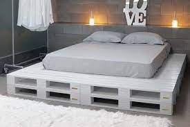 Put some paintings next to the bed on the wall to make it more colorful. Diy Chic White Platform Pallet Bed 99 Pallets Diy Pallet Bed Pallet Furniture Wooden Pallet Beds