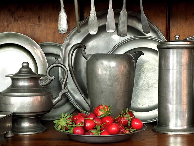 Authentic colonial-era pewter and metalware are highly prized by American antique collectors., AI generated