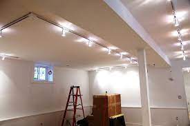 With the rotation of the light fixtures i was thinking i might still be able to direct them enough to get good illumination throughout the room if i put up a the last basement i did with the same problem, i put flourescent lighting in between the joists, effective but not pretty. Basement Ceiling Lighting Basement Lighting Basement Light Fixtures Low Ceiling Lighting