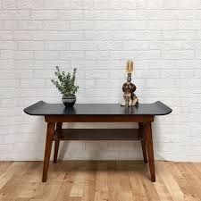 But, you can actually benefit from one if you get the unit that serves several purposes like a coffee table with storage baskets! Upcycled Mid Century Coffee Table Hand Painted Ash Dark Grey Natural Wood Danish Curved Edge 1960s Retro Under Shelf Storage Side Table Dolly Did It Vinterior