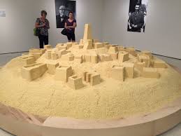 Kader attia untitled (couscous), 2009 floor sculpture, couscous, black acrylic paint, spotlight exhibition view, 2018 „scars remind us that our past is real fundacio joan miro , barcelona photo: Kelly Art Geek Nyc On Twitter Kader Attia S Scale Model Of An Algerian City Sculpted In Couscous Guggenheim Art Sculpture Museum Installation