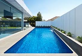 Aesthetically Pleasing Wedge Pool In Altona With Glass Pool Fencing And Pool Waterfall Pool Landscape Design Swimming Pools Inground Backyard Pool Landscaping