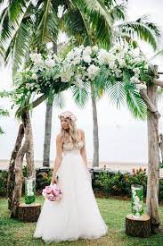 Wedding arch decorated with flowers on tropical sand beach, outd. 50 Green Tropical Leaves Wedding Ideas Tropical Wedding Dresses Palm Wedding Wedding Arch