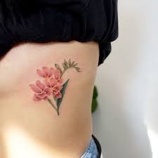 22 Beautiful And Delicate Freesia Tattoo Designs Tattooadore Pastel Tattoo Flower Tattoo Pink Flower Tattoos