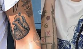 According to hollywood life, harry's broken heart half tattoo is barely visible in a fan's instagram photo that has been reposted over 1000 times. One Direction S Louis Tomlinson Gets Dagger Tattoo Yahoo Celebrity Uk