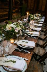 Red, green colors, pine cone centerpieces, candles and reindeer figures. 30 Cozy Rustic Wedding Table Decor Ideas Weddingomania