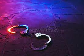 handcuffs on the floor at night open handcuffs on the street pavement at night ad open handcuffs str police car lights handcuffs high contrast images