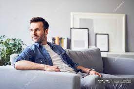 See more ideas about drawing poses, pose reference, drawing reference. Smiling Relaxed Man Sitting On Sofa And Looking Away Vision Resting Stock Photo 258937452