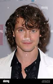 Hugh Dancy poses as he arrives at the Ella Enchanted premiere held at the  Beekman theatre in New York,