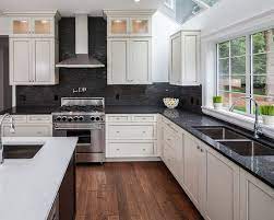 While the backsplash in the above kitchen stands slightly off of the countertops, it's still a passive, lower contrast combination. Amazing Black Kitchen Cabinets Trend For 2018 Black Kitchen Cabinets Diy Black Kitchen Countertops Trendy Kitchen Backsplash White Cabinets Black Countertops
