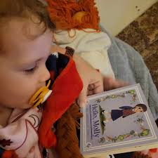 We celebrated a birthday yesterday and one of the presents was a book, but  of course. After cake, presents, and a bath, it was story time with the new  book and baby