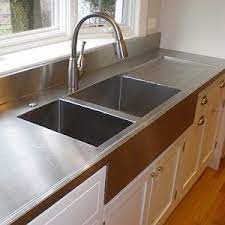 Stainless steel countertops are available in a variety of finishes. Diy Stainless Steel Countertops An Easy To Follow Guide Stainless Steel Kitchen Countertops Metal Countertops Steel Kitchen Cabinets