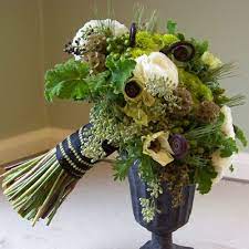 Modern orange, white & green bouquet with fun textures orange, yellow, green, ranunculus, roses, berries, round shape. Bridesmaid Bouquet With Black Privet Berries Uluhe Fern Curls Black And White Anemones White Ranunculus Stellata Loose Bouquet Green Bouquet Bridal Bouqet