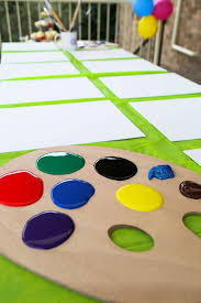 Use everything to make a splatter paint table runner. Bright And Easy Art Theme Party Meraki Mother