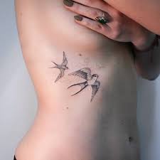 Bird Tattoo On Ribs Swallows Ribs Tattoo By Irene Bogachuk Bird Tattoo Ribs Swallow Bird Tattoos Rib Tattoo