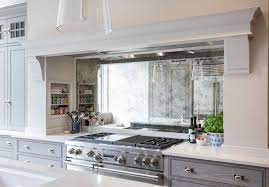 It is for those who can afford to keep their kitchen absolutely clean and probably spend far less time in the kitchen than the average homemaker. Backsplash Behind The Stove Kitchen Design Mirror Backsplash White Cabinets Kitchen Mirror Mirror Backsplash Kitchen Elegant Tile Backsplash