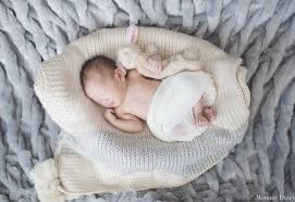 If you can't track down a chair, simply have mom and dad hold the sheet up in the air, and let it pillow at the ground. Diy Newborn Photography Mommy Diary