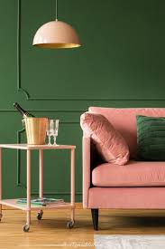 Give a narrow space a longer feel with a rich accent wall color, like this green kitchen backsplash. Green Paint Colors Love Remodeled