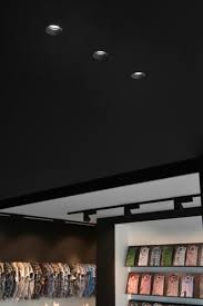 Three Aplis In Line Downlights Integrated In Black Plasterboard Ceiling And Black Erubo Spotlights On Track Retail Lighting Lighting Inspiration Downlights