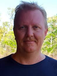 Why is Darwin dominated by air-conditioned, concrete bunker-type houses  with small backyards?