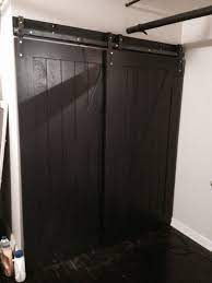 another bypass barn door system installed this time it s with black doors bold barn door shed door hardware sliding barn door closet