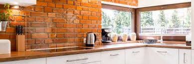Foto de cocina en l, actual, de tamaño medio, abierta, con encimera de granito, fregadero bajoencimera, armarios con paneles lisos. Modern Kitchen Corner With A Stylish Brick Wall And A Large Horizontal Stock Photo Picture And Royalty Free Image Image 65557307