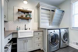 The perfect greige cabinets, paired with traditional subway tile and wood counter tops and hangers makes for a beautiful farmhouse laundry room design. 11 Farmhouse Laundry Room Ideas 2021