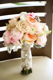 Check out this burlap bouquet wrap with jeweled broach and see more inspirational photos on theknot.com. Burlap Lace Ribbon And Brooch Bouquet Wrap 25 00 Via Etsy Wedding Bouquets Lace Bouquet Bouquet Wrap