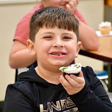 Students in Mrs. Ezman's first-grade class at Willard Prior Elementary  gathered with excitement to celebrate a special occasion: a classmate's  seventh birthday!